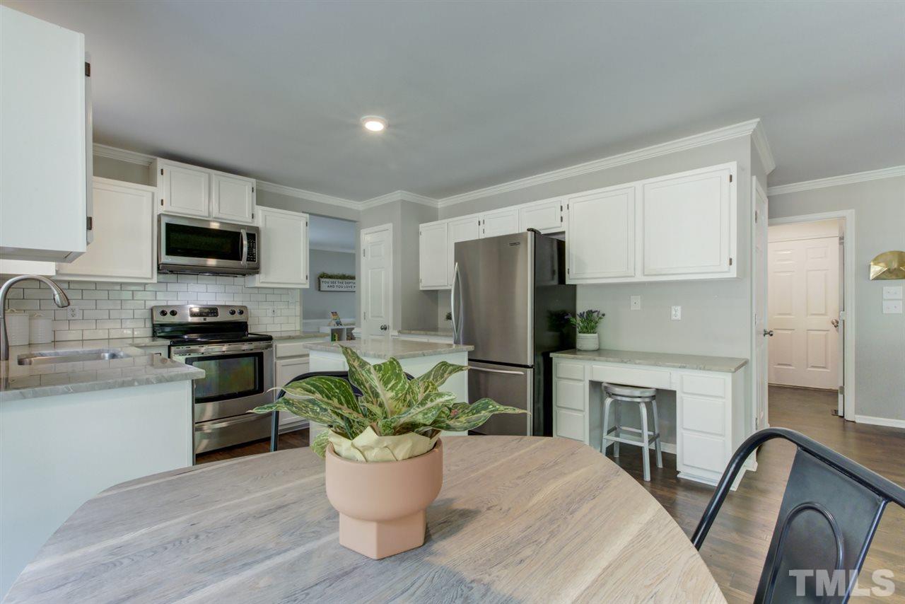 5516 Banwell Place Raleigh, NC 27613 - Photo 10 of 30 This view of kitchen highlights desk area. Kitchen includes a pantry for storage needs