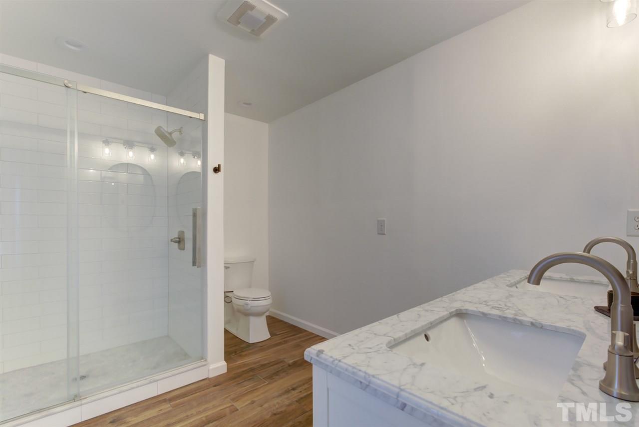 5516 Banwell Place Raleigh, NC 27613 - Photo 20 of 30 Remodeled Master Bathroom includes walk in shower with beautiful tile and new flooring