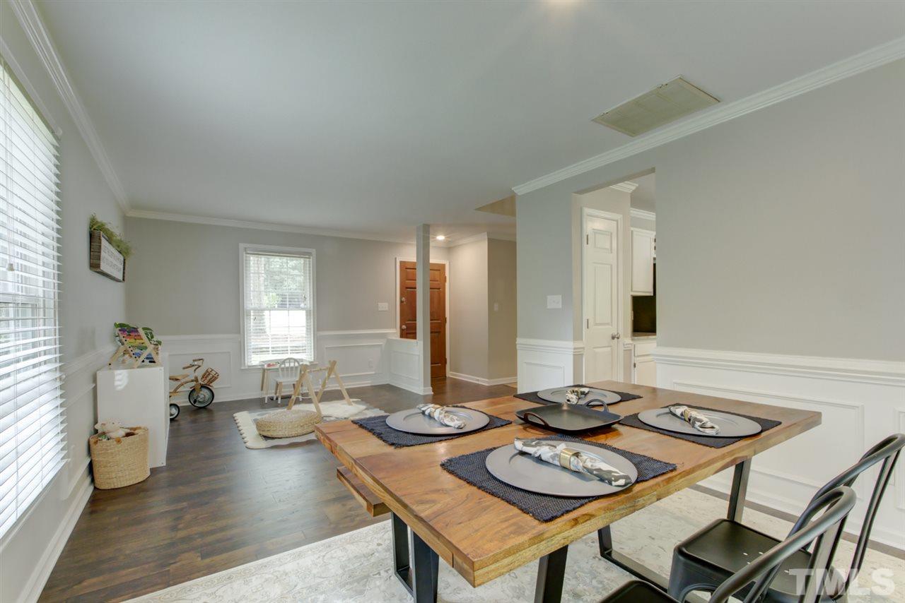 5516 Banwell Place Raleigh, NC 27613 - Photo 30 of 30 Another view of open floor plan area that highlights molding and engineered hardwoods