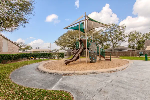 a view of a playground with basketball court