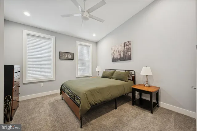 a bedroom with a bed a window and couch