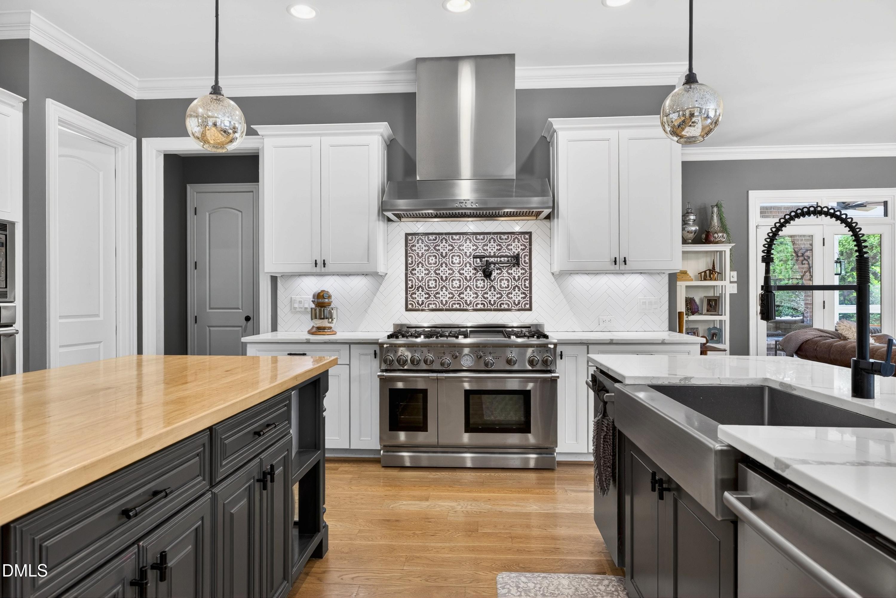 3513 Eilla Bluffs Court Raleigh, NC 27606 - Photo 20 of 86 a kitchen with stainless steel appliances granite countertop a sink stove and refrigerator