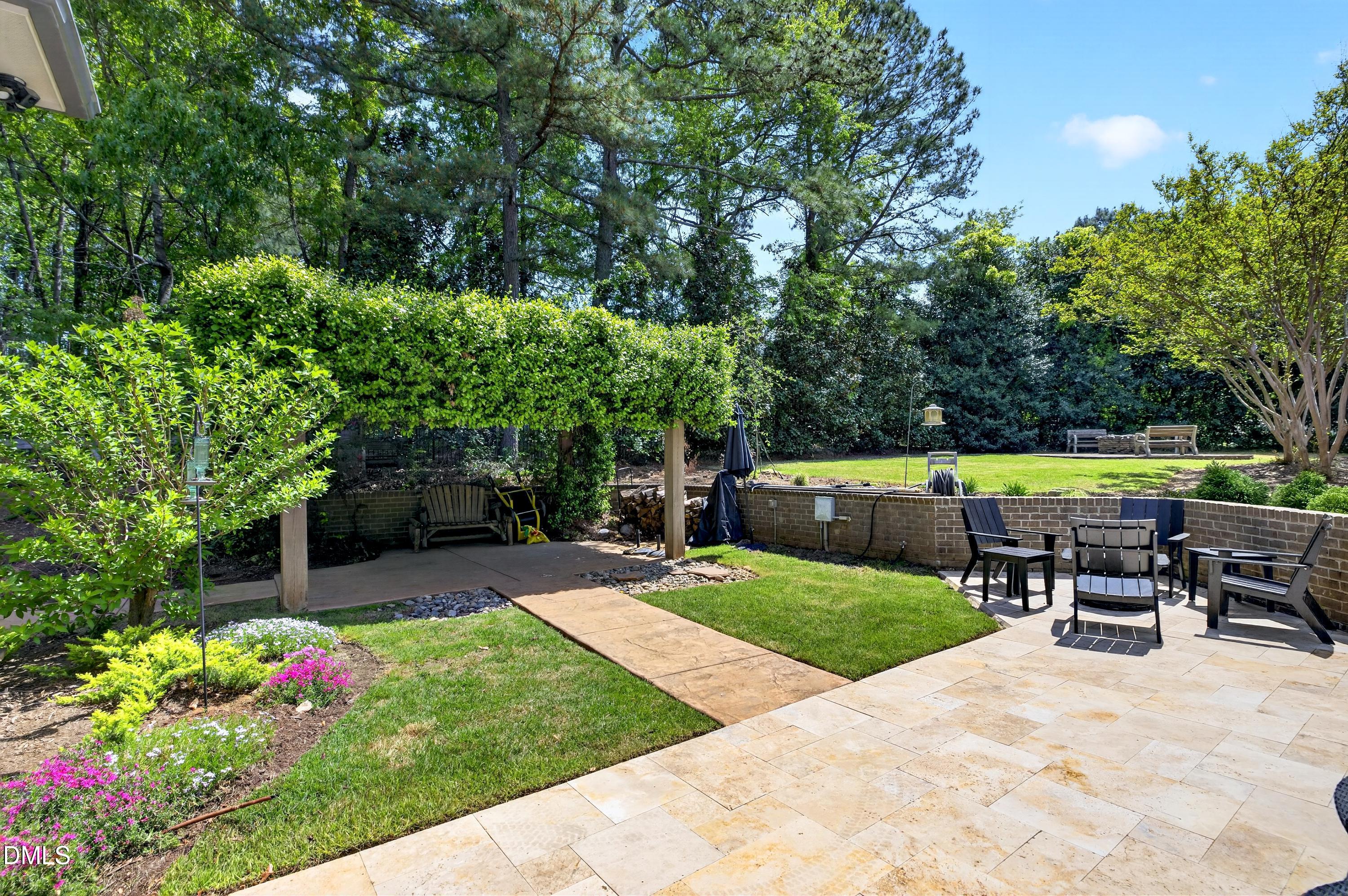3513 Eilla Bluffs Court Raleigh, NC 27606 - Photo 78 of 86 a view of a patio with a table and chairs under an umbrella