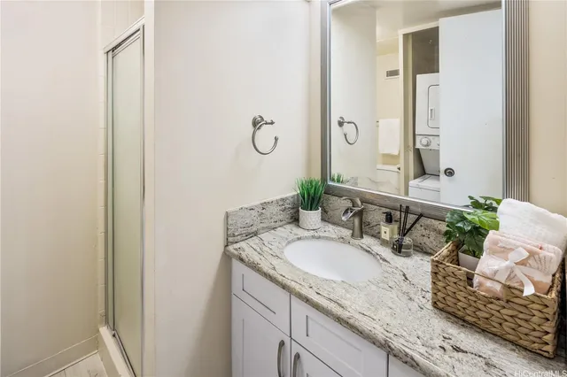 a bathroom with a granite countertop sink and a mirror