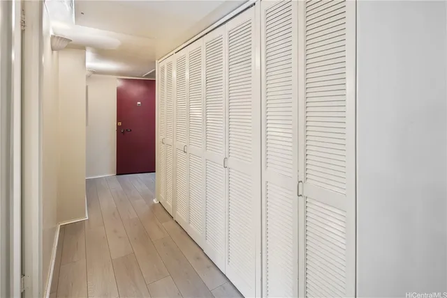 a view of a hallway with wooden floor
