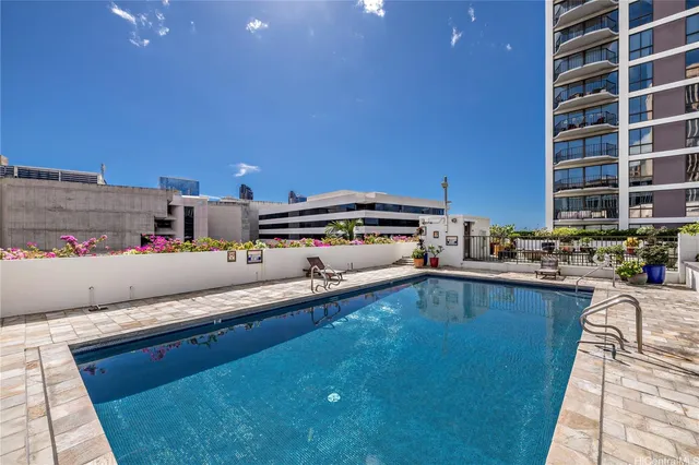 a living room with stainless steel appliances kitchen island granite countertop a sink and cabinets