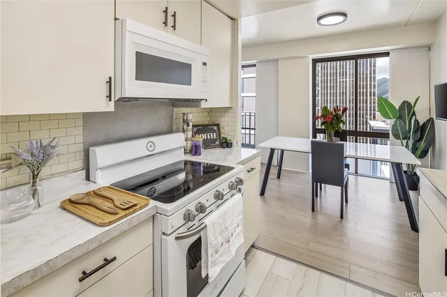 a kitchen with a stove cabinets and wooden floor