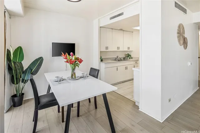 a view of a dining room with furniture and wooden floor