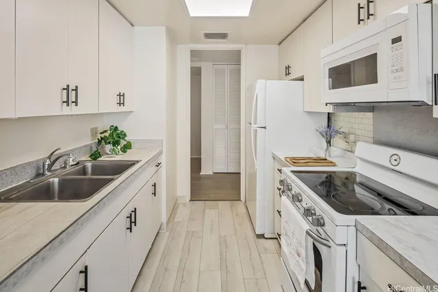 a kitchen with a sink stove and refrigerator