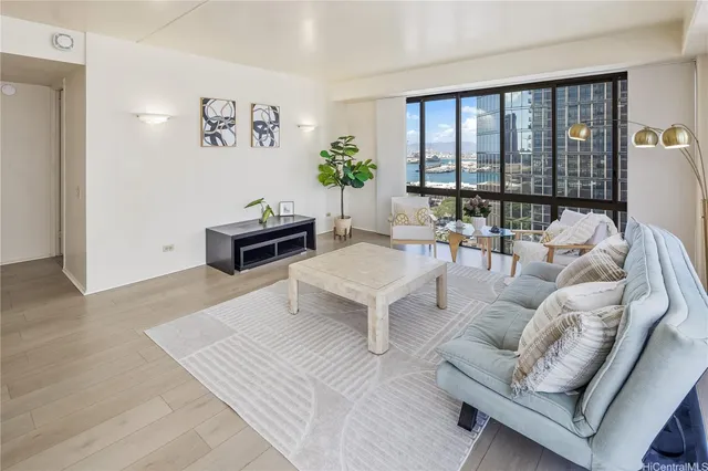 a living room with furniture and large windows