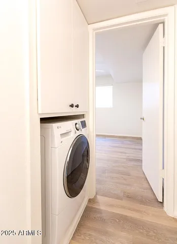 a view of a hallway with washer and dryer