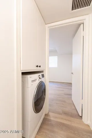 a view of a hallway with washer and dryer
