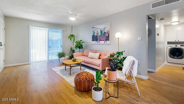 a living room with furniture and wooden floor