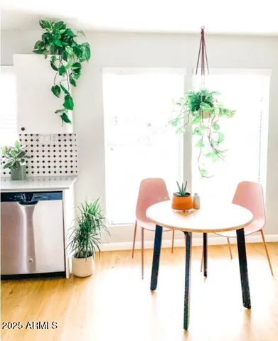 a view of a dining room with furniture and a potted plant
