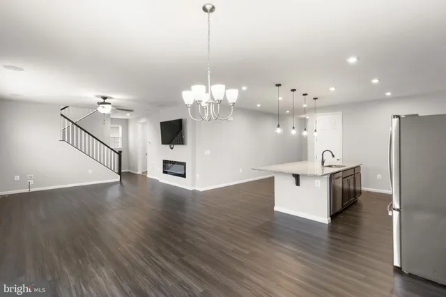 a view of a kitchen and dining room with wooden floor