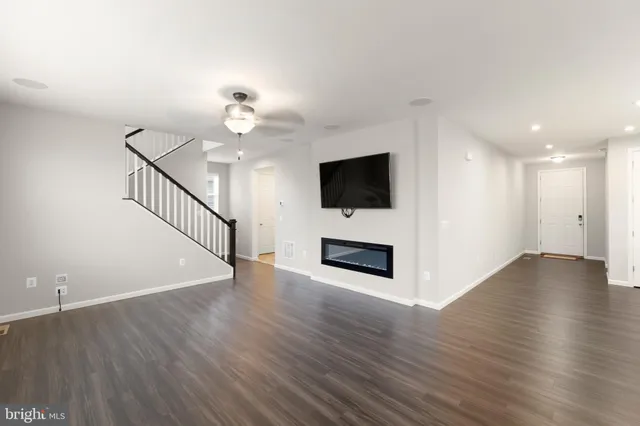 a view of a kitchen with wooden floor and a fireplace