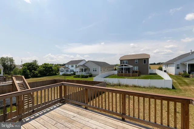a view of city from a balcony with furniture