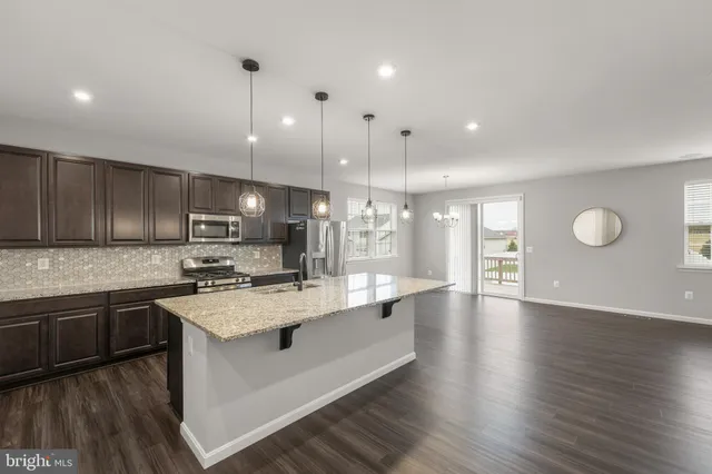 a large kitchen with stainless steel appliances lots of counter top space