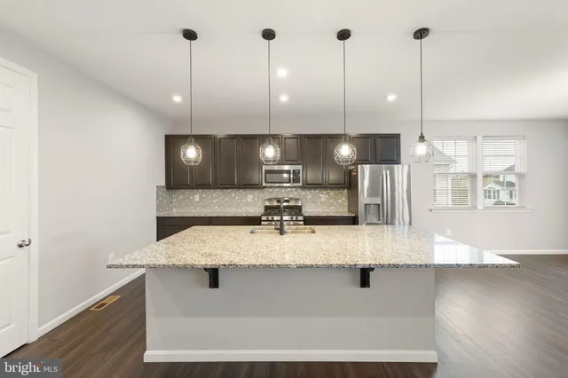 a large kitchen with kitchen island a large island in the center