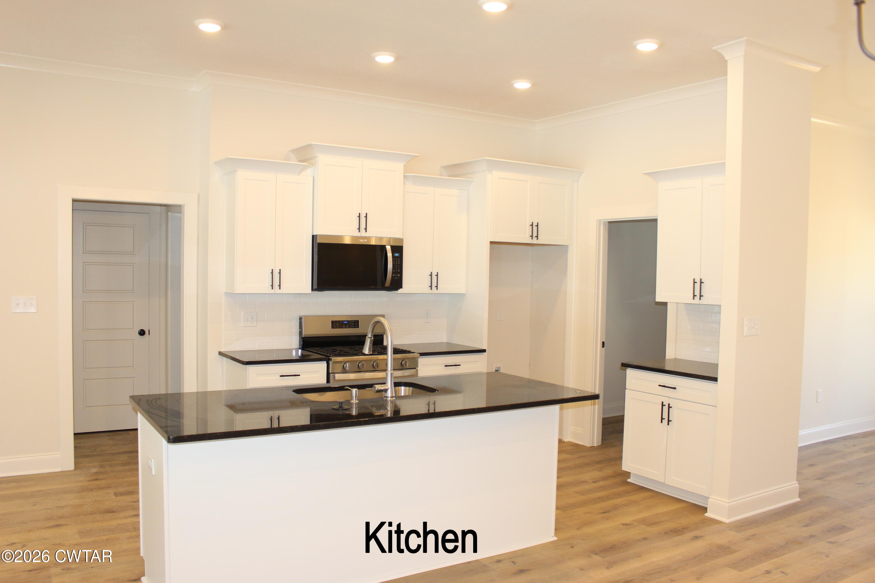 148 Calumet Cove Medina, TN 38355 - Photo 3 of 21 a kitchen with stainless steel appliances granite countertop a sink a stove and a refrigerator