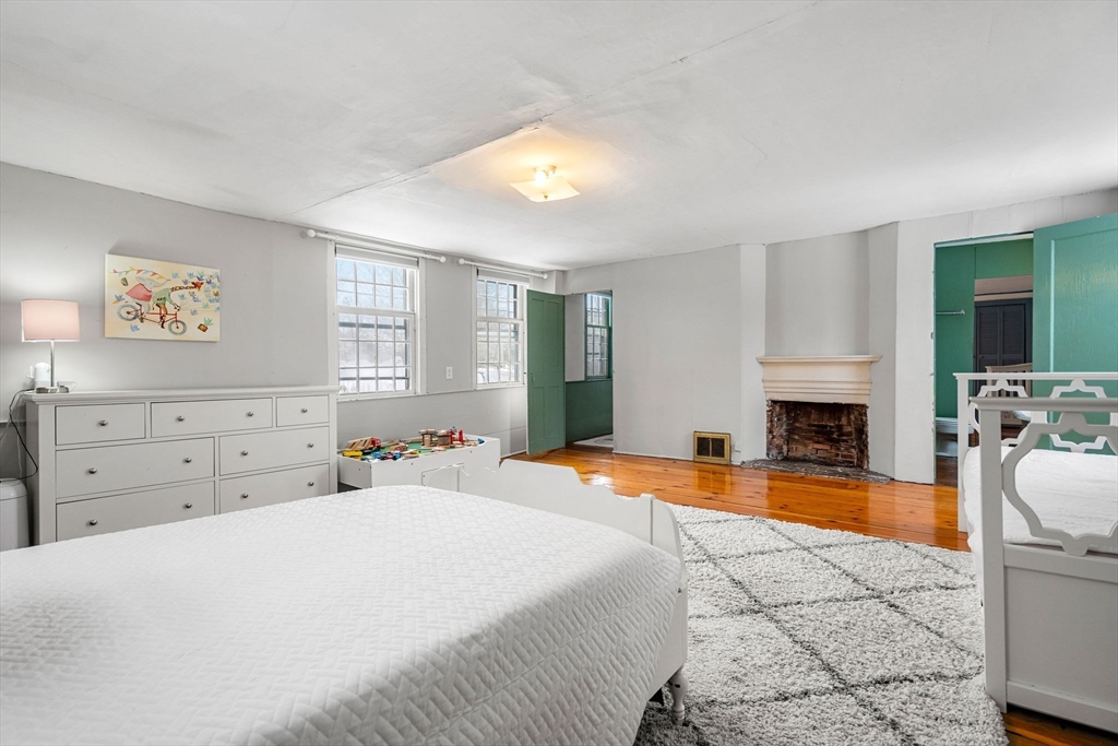 4 Thorndike Street Dunstable, MA 01827 - Photo 22 of 35 a bedroom with a bed and a fireplace