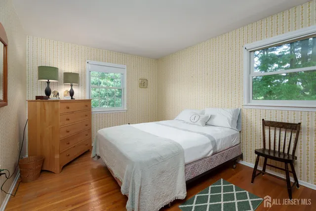 a bedroom with a bed chair and a window