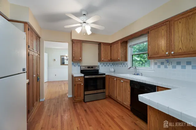 a kitchen with wooden floors and white appliances