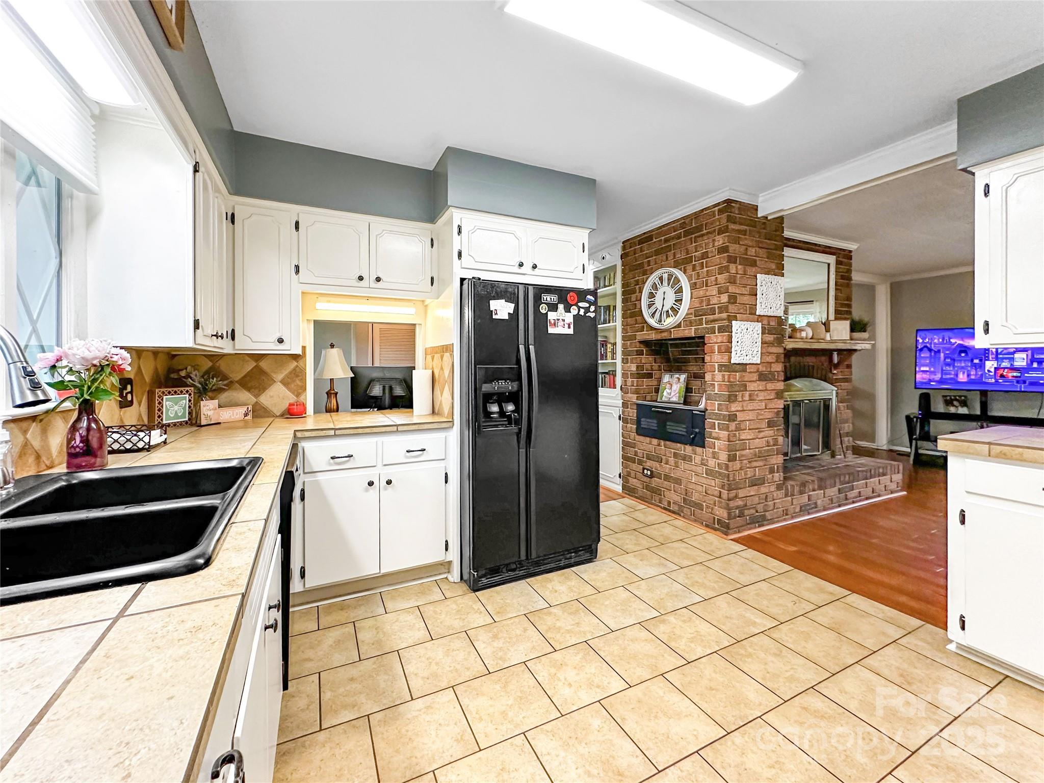 200 Woodside Drive Morganton, NC 28655 - Photo 17 of 48 a kitchen with stainless steel appliances kitchen island granite countertop a refrigerator a stove top oven and a sink