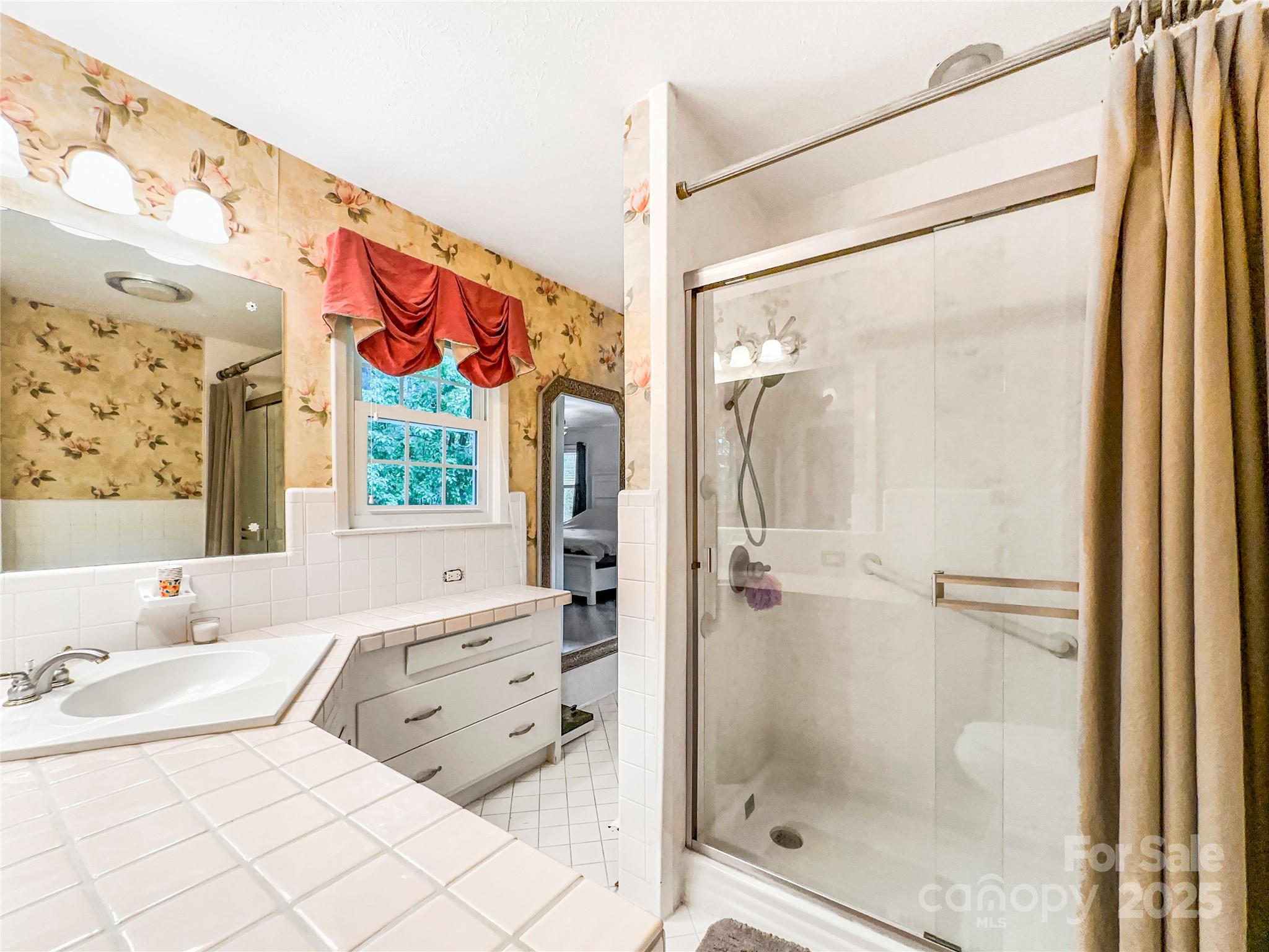 200 Woodside Drive Morganton, NC 28655 - Photo 25 of 48 a bathroom with a granite countertop sink mirror and shower
