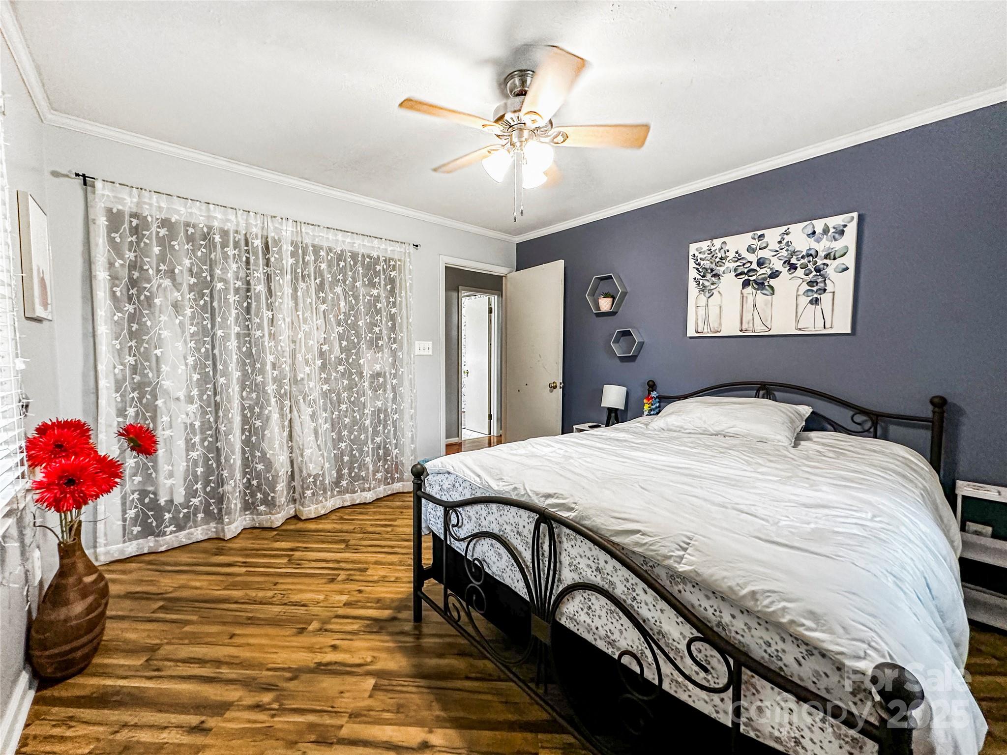 200 Woodside Drive Morganton, NC 28655 - Photo 28 of 48 a spacious bedroom with a bed and a chandelier