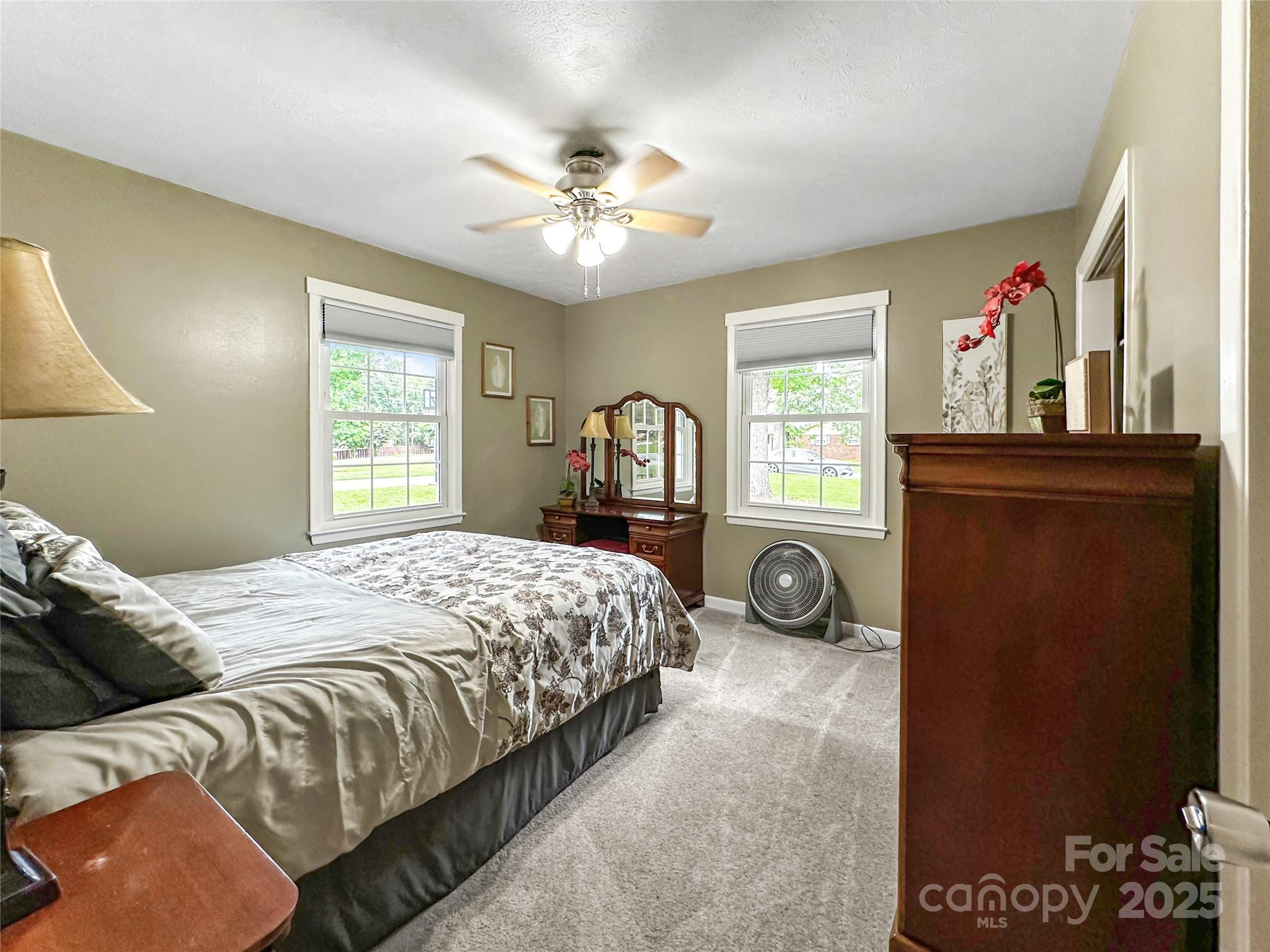 200 Woodside Drive Morganton, NC 28655 - Photo 31 of 48 a bedroom with a bed and a chandelier