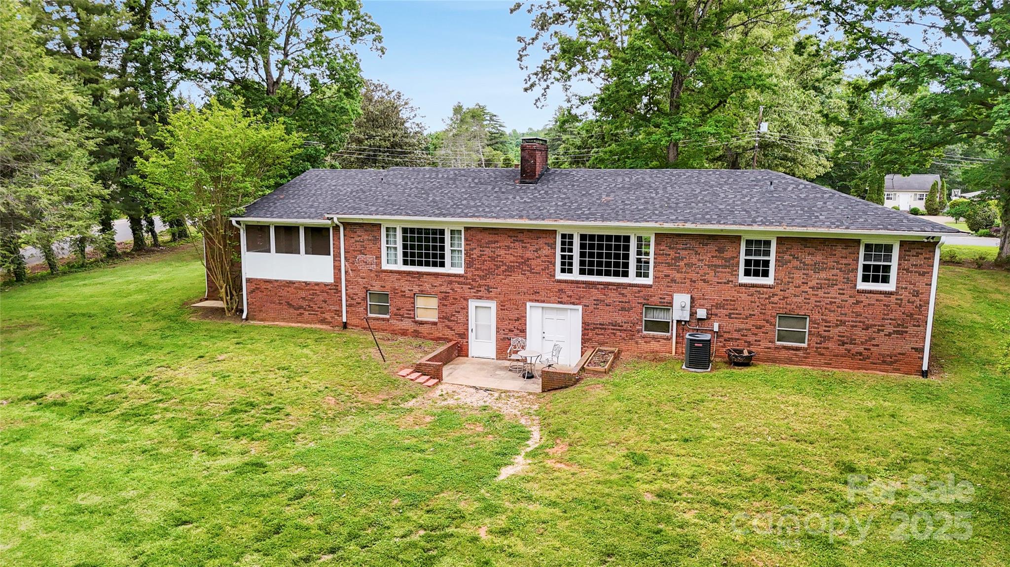 200 Woodside Drive Morganton, NC 28655 - Photo 6 of 48 a front view of a house with a garden and trees