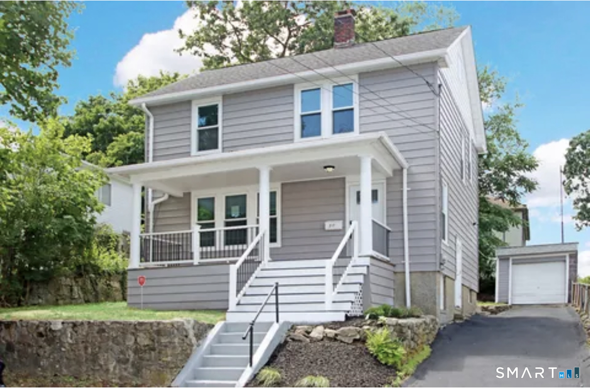 a front view of a house with a garden
