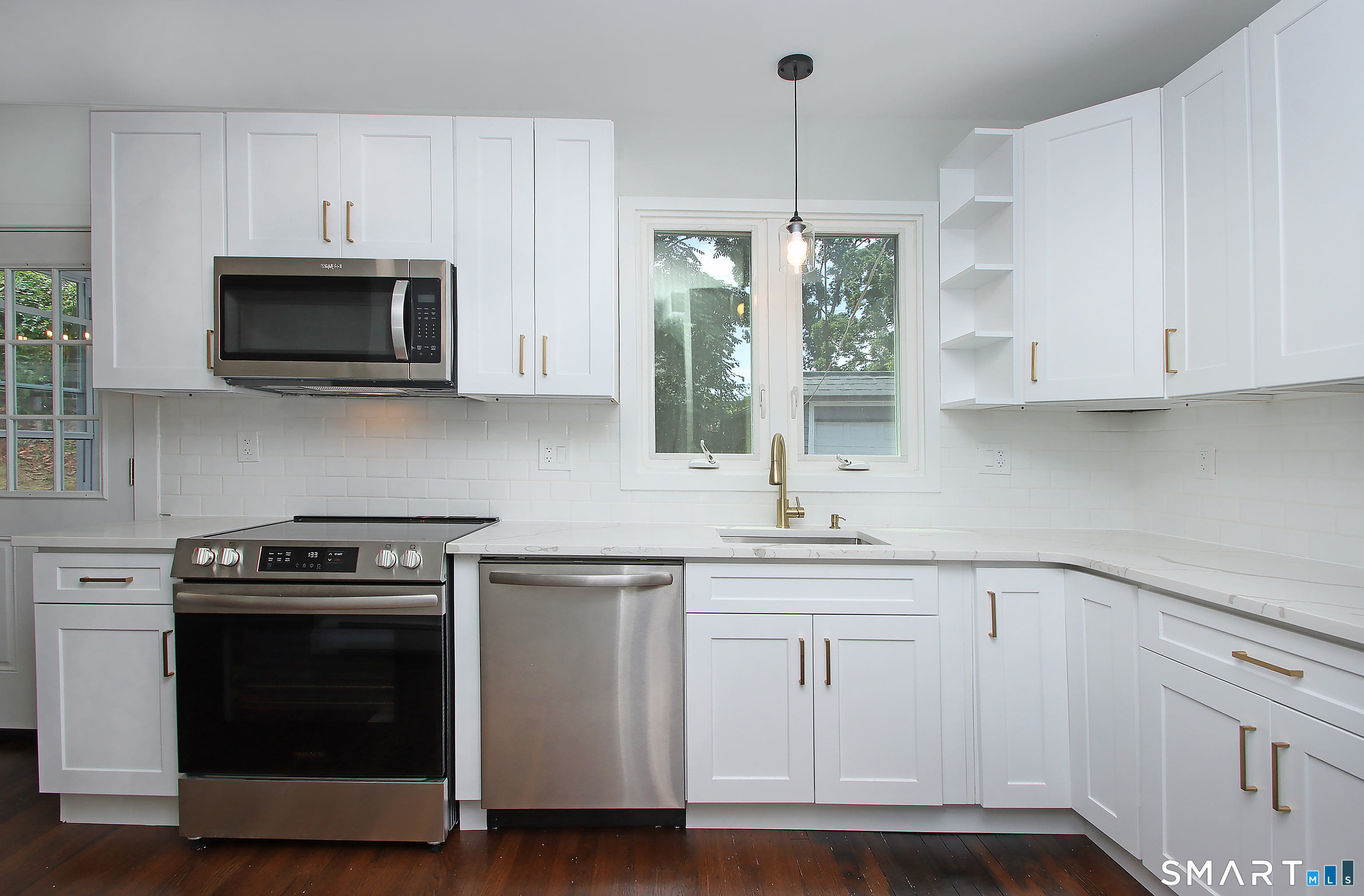 217 Ledgeside Avenue Waterbury, CT 06708 - Photo 13 of 24 a kitchen with white cabinets and stainless steel appliances