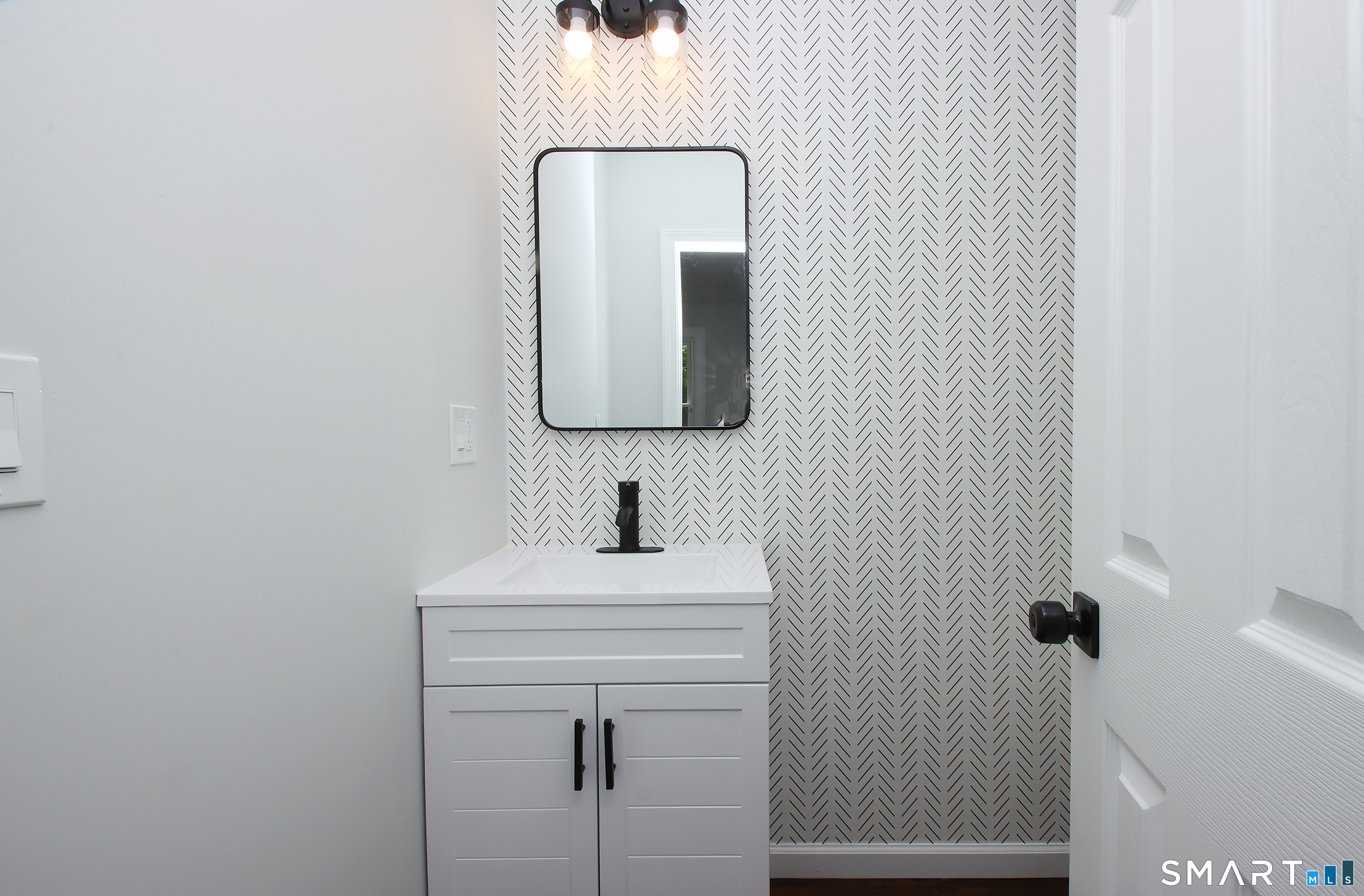 217 Ledgeside Avenue Waterbury, CT 06708 - Photo 14 of 24 a bathroom with a sink and a mirror