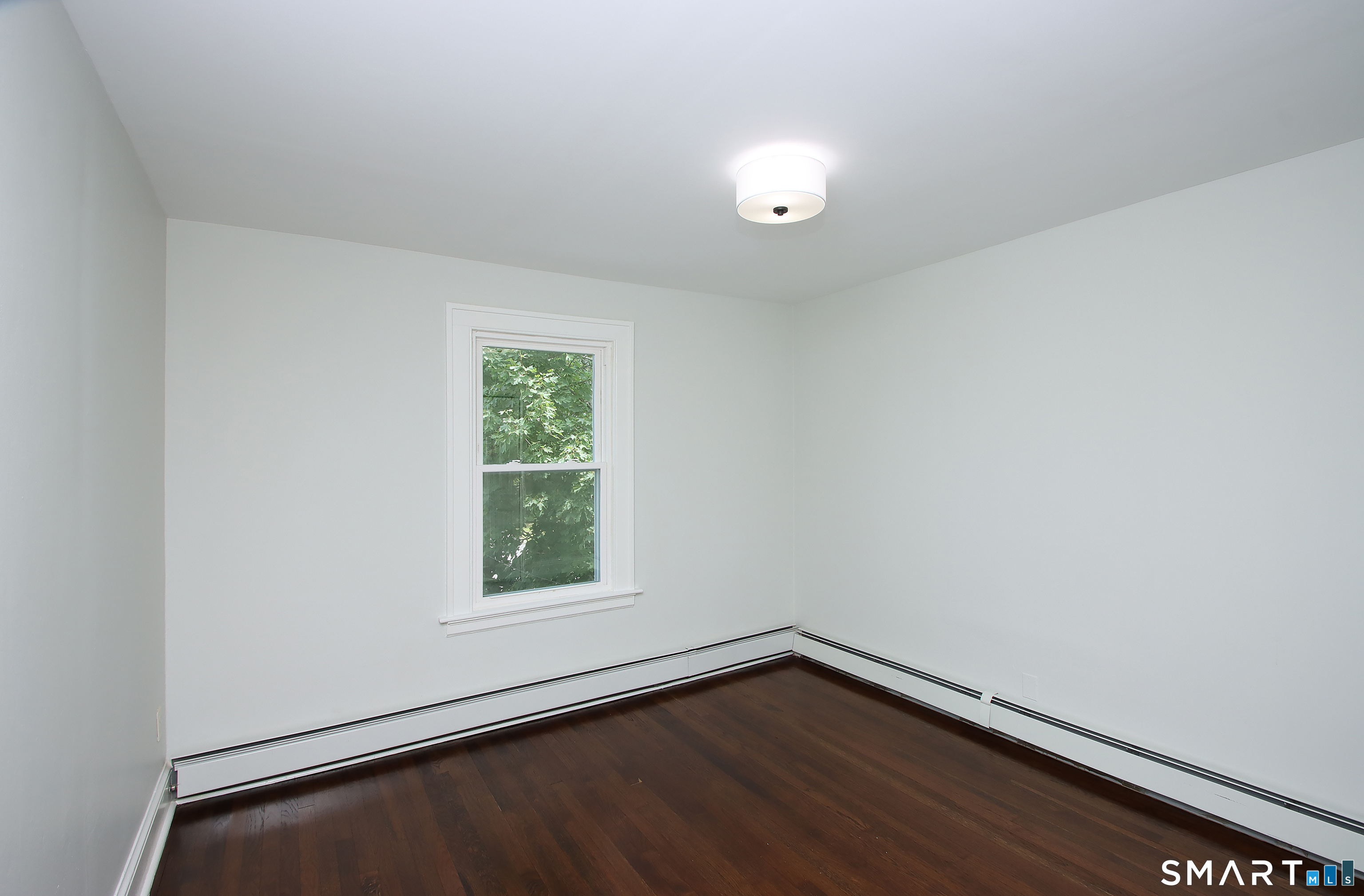 217 Ledgeside Avenue Waterbury, CT 06708 - Photo 19 of 24 wooden floor in an empty room with a window