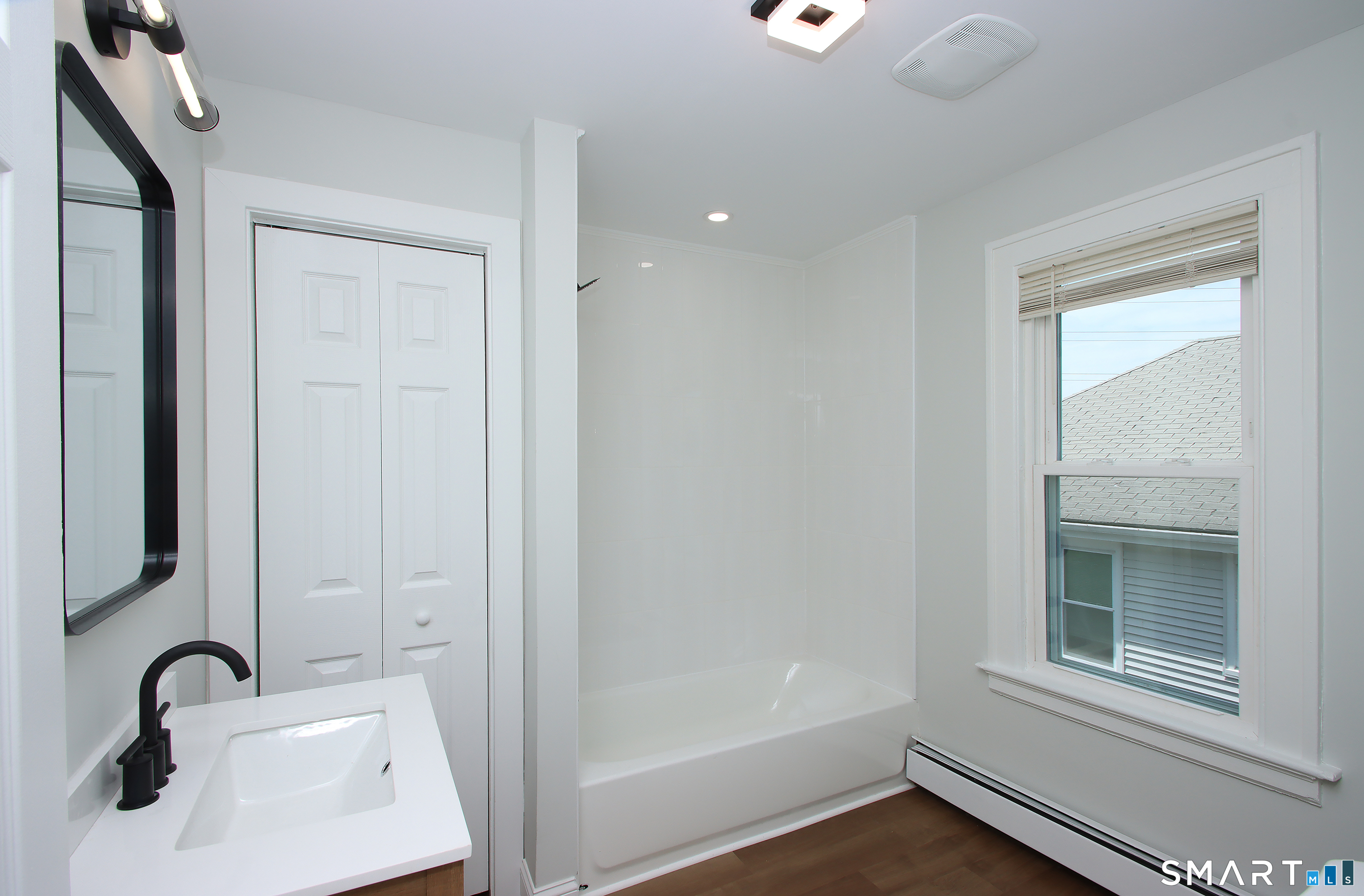 217 Ledgeside Avenue Waterbury, CT 06708 - Photo 21 of 24 a bathroom with a sink and a mirror