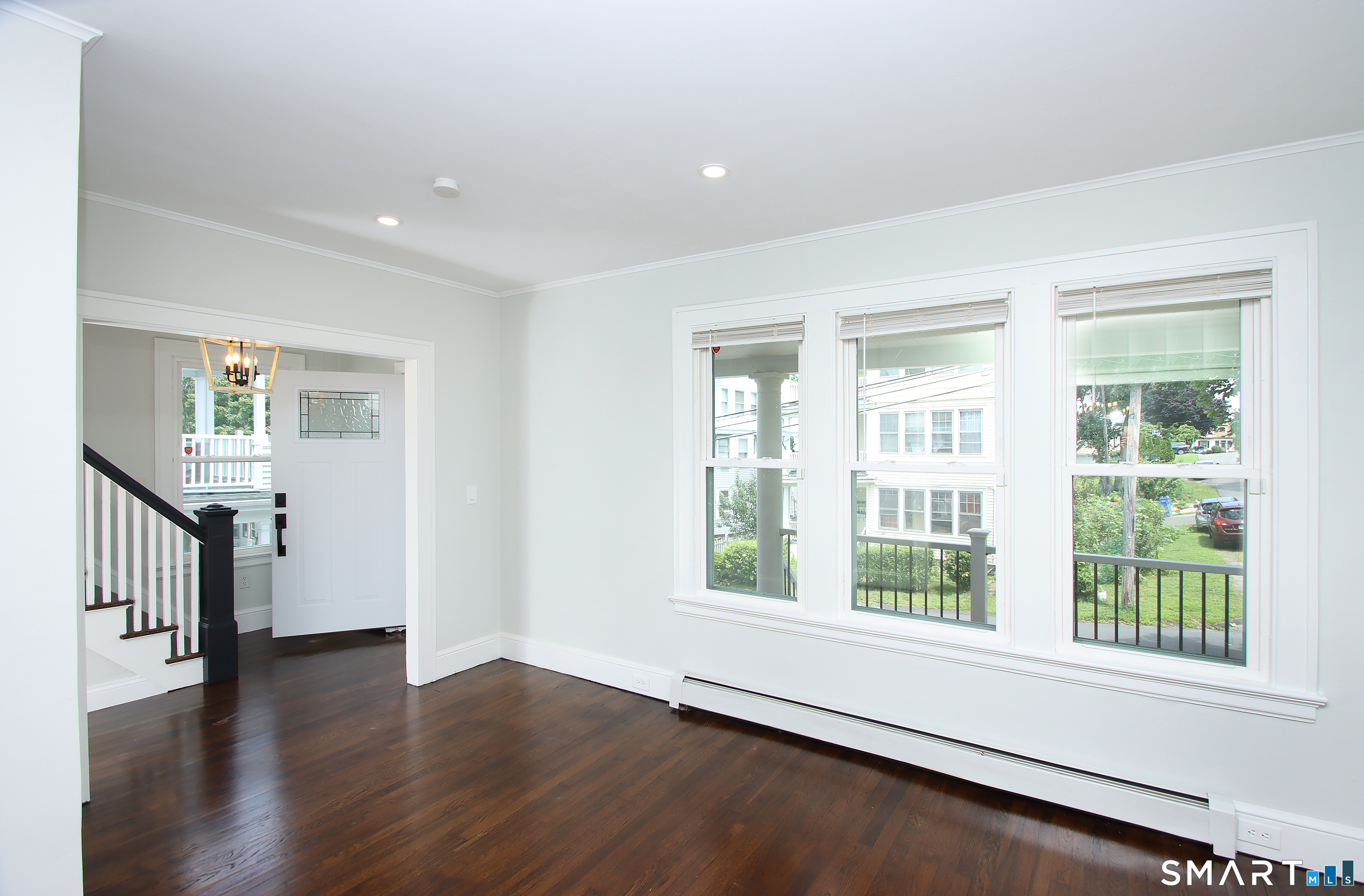 217 Ledgeside Avenue Waterbury, CT 06708 - Photo 3 of 24 a view of an empty room with wooden floor and a window