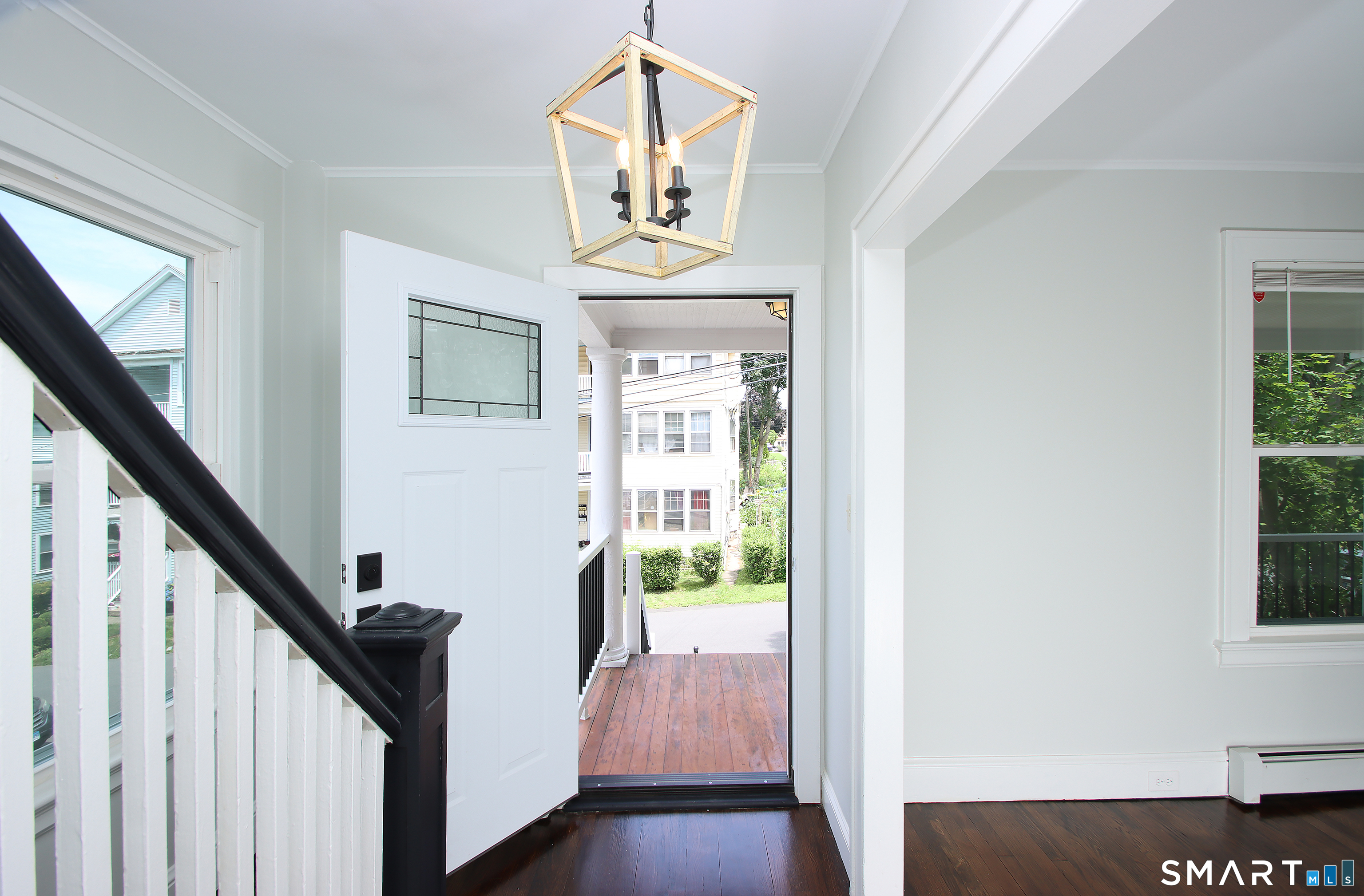 217 Ledgeside Avenue Waterbury, CT 06708 - Photo 4 of 24 a view of hallway with stairs and wooden floor