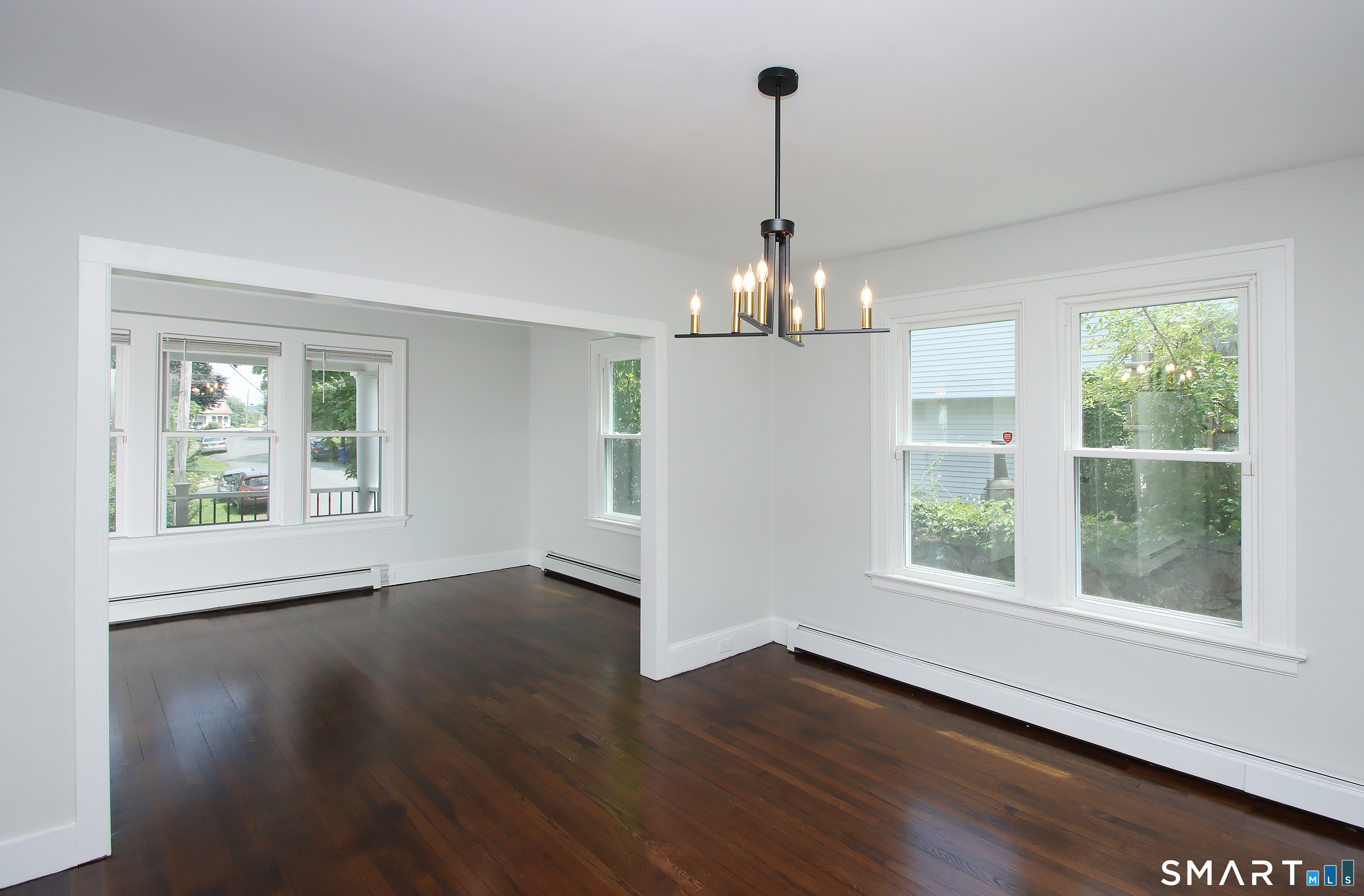 217 Ledgeside Avenue Waterbury, CT 06708 - Photo 7 of 24 a view of an empty room with wooden floor and a window