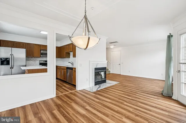 a view of kitchen with sink and refrigerator