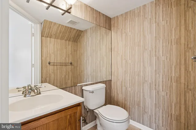 a bathroom with a sink a toilet and shower curtain