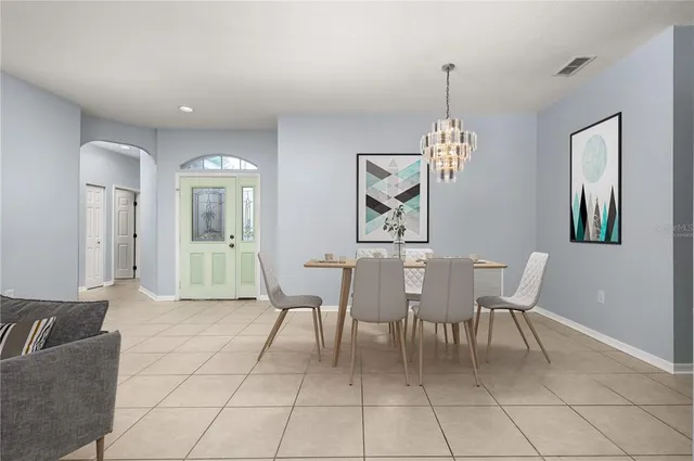 a view of empty room with window and chandelier