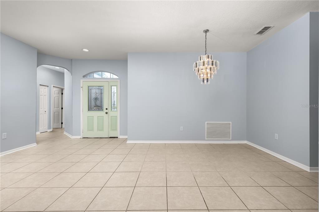 8231 Southwest 79th Court Ocala, FL 34476 - Photo 13 of 39 a view of empty room with window and chandelier