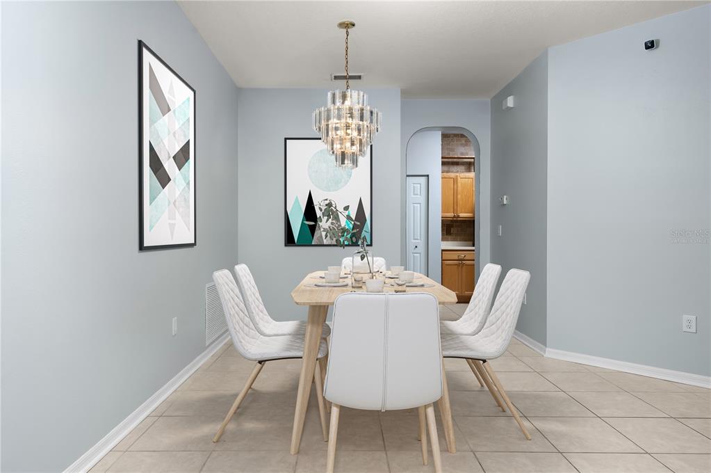 8231 Southwest 79th Court Ocala, FL 34476 - Photo 14 of 39 a dining room with furniture a chandelier and window