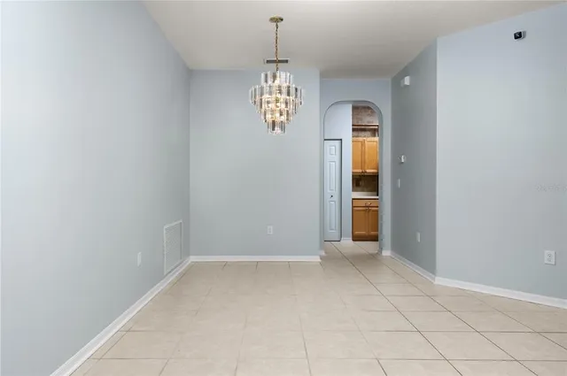 a kitchen with granite countertop a stove a sink and a microwave