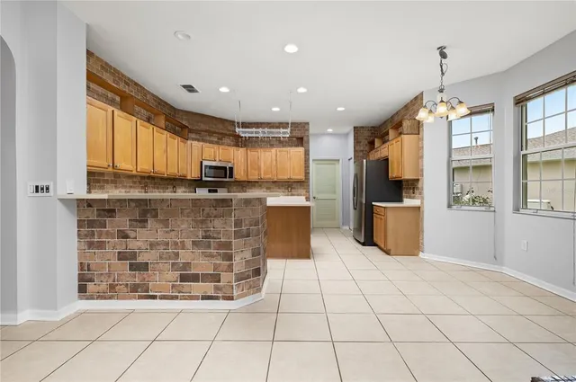 a kitchen with stainless steel appliances a stove a sink and a refrigerator