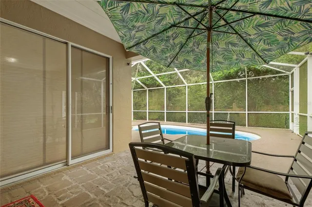 a dining room with furniture and a window