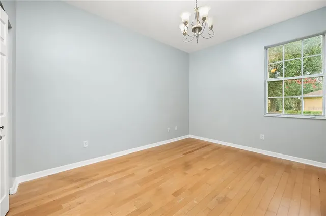 a bed room with a bed and a painting on the wall