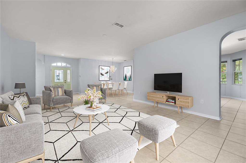 8231 Southwest 79th Court Ocala, FL 34476 - Photo 6 of 39 a living room with furniture and a flat screen tv